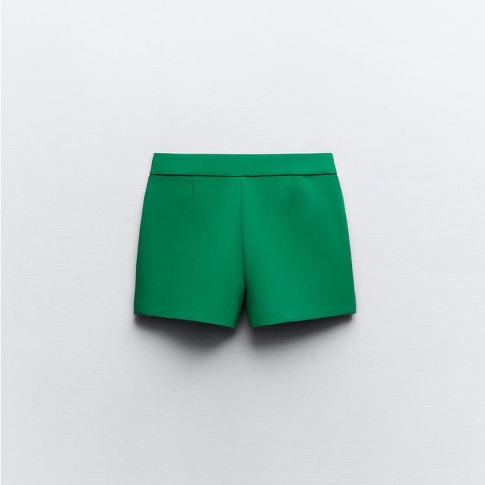 asymmetrical skort. Front false welt pocket, hidden in-seam zip closure.